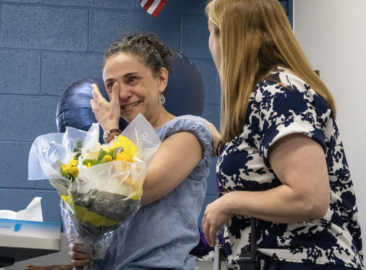 ONE FOR THE BOOKS: While English Teacher Lisa Neu (left) was teaching her Block 2 AP Language and Composition class, she received a visit from Principal Dr. Barbara Georges (right) who delivered the news that Neu will receive the Distinguished Teacher Award. After the announcement, Neu’s students congratulated her as she celebrated her achievement. 
